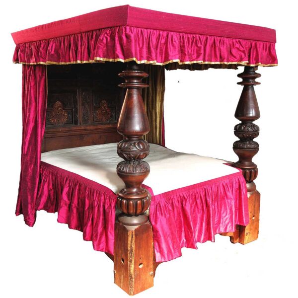 An antique four poster or full tester bed in Elizabethan style