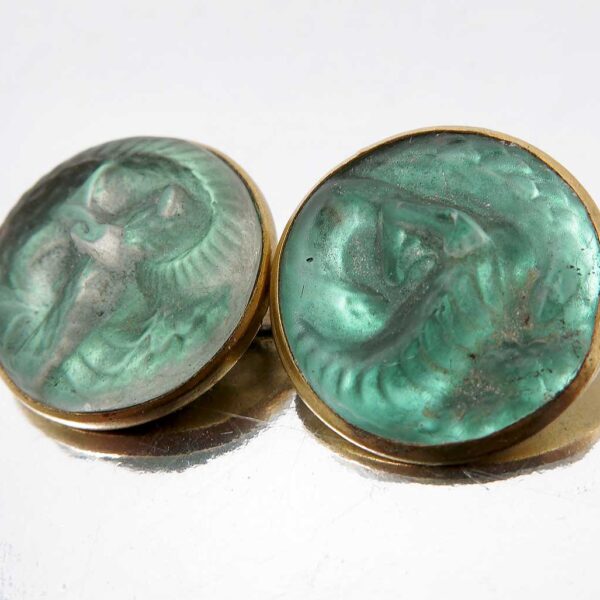 A pair of Lalique green glass cufflinks, moulded with serpents in a green glass
