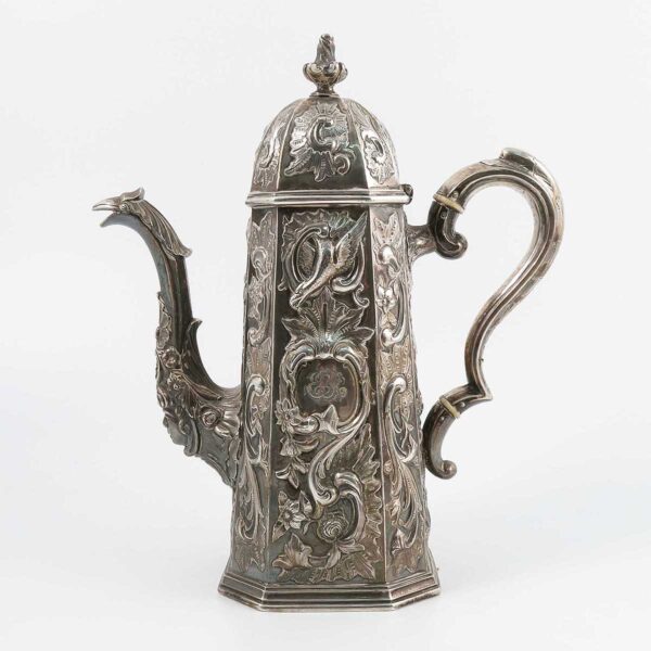 An Irish silver coffee pot, with canted domed cover to the tapered canted base