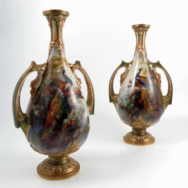 A pair of Royal Worcester vases, of baluster form, with moulded neck and leaf moulded handles