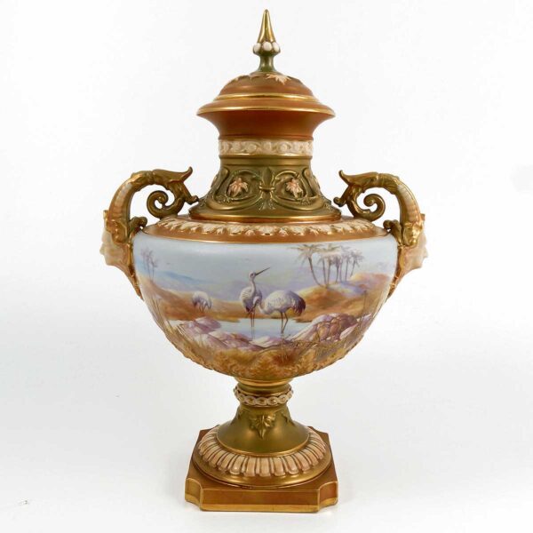 A Royal Worcester covered vase, with gilded moulded neck, mask handles