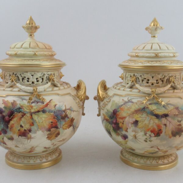 A pair of Royal Worcester blush ivory Bow piece vases, decorated in autumnal colours with leaves